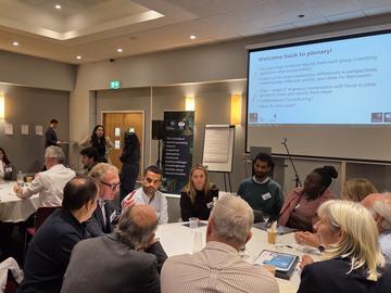 Delegates engaged in discussion around a conference table.